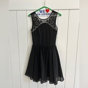 Elegant Black Sleeveless Dress with Sheer Embellished Neckline